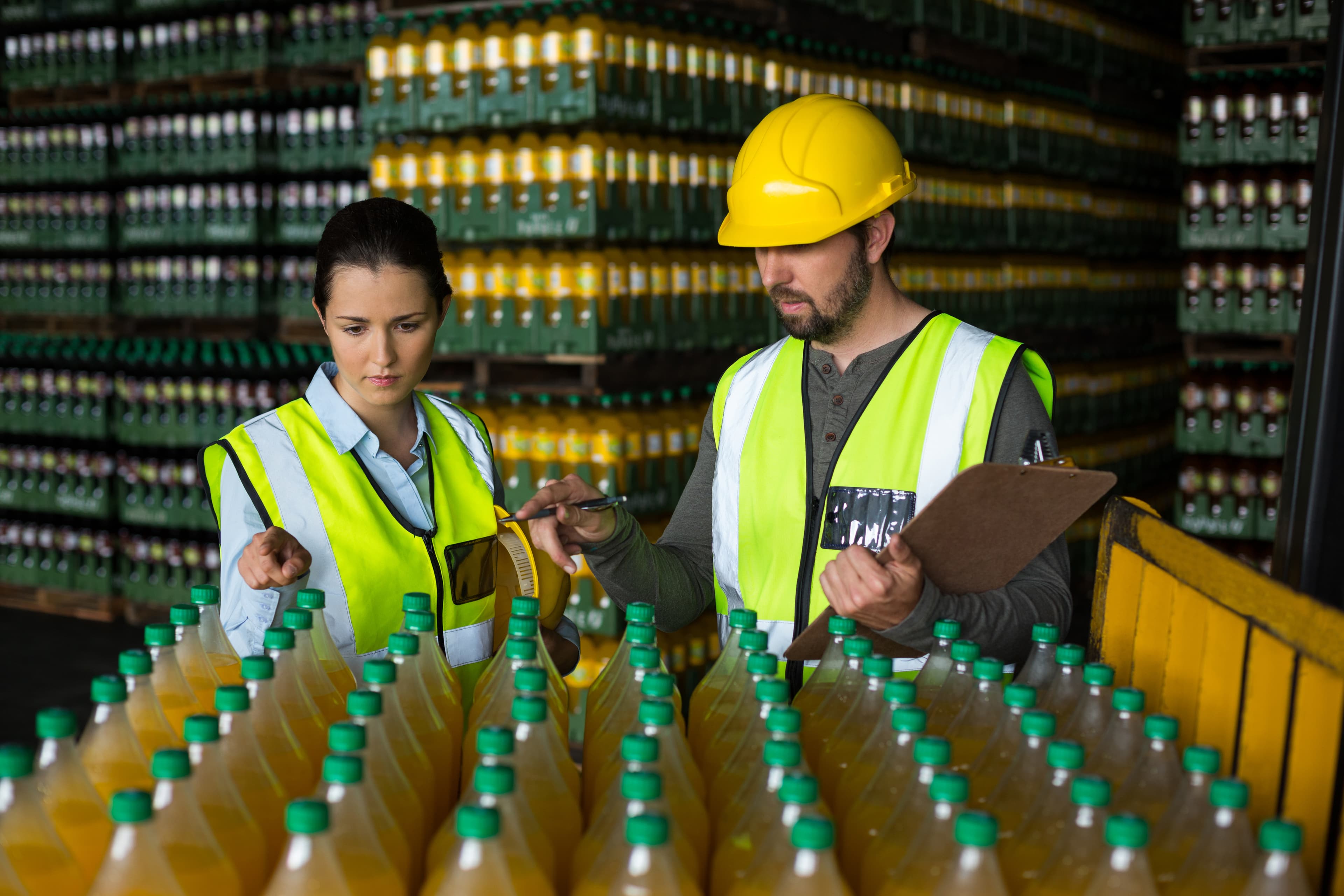 Factory workers monitoring drink bottles